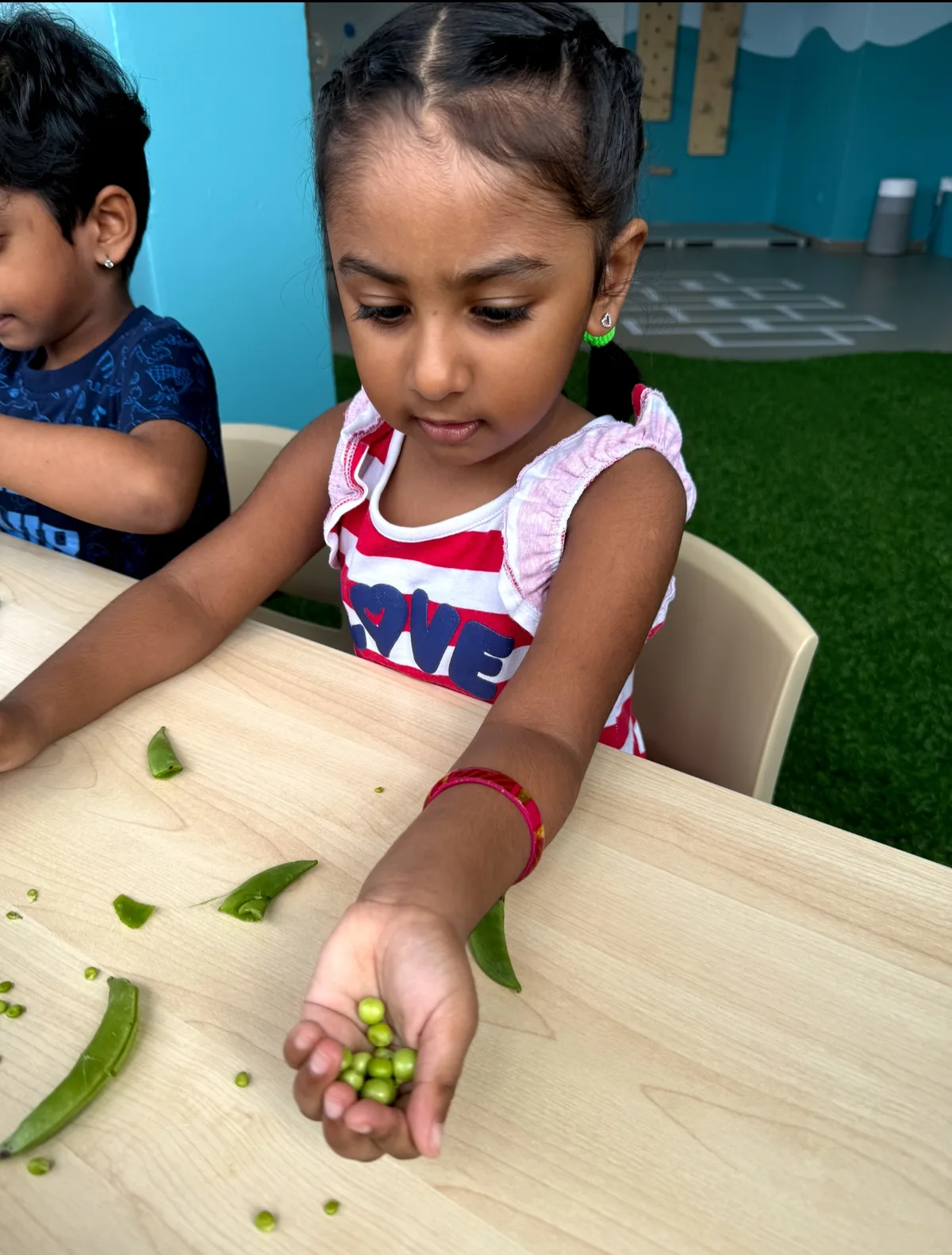 Child exploring freshly harvested vegetables during a Garden to Table activity