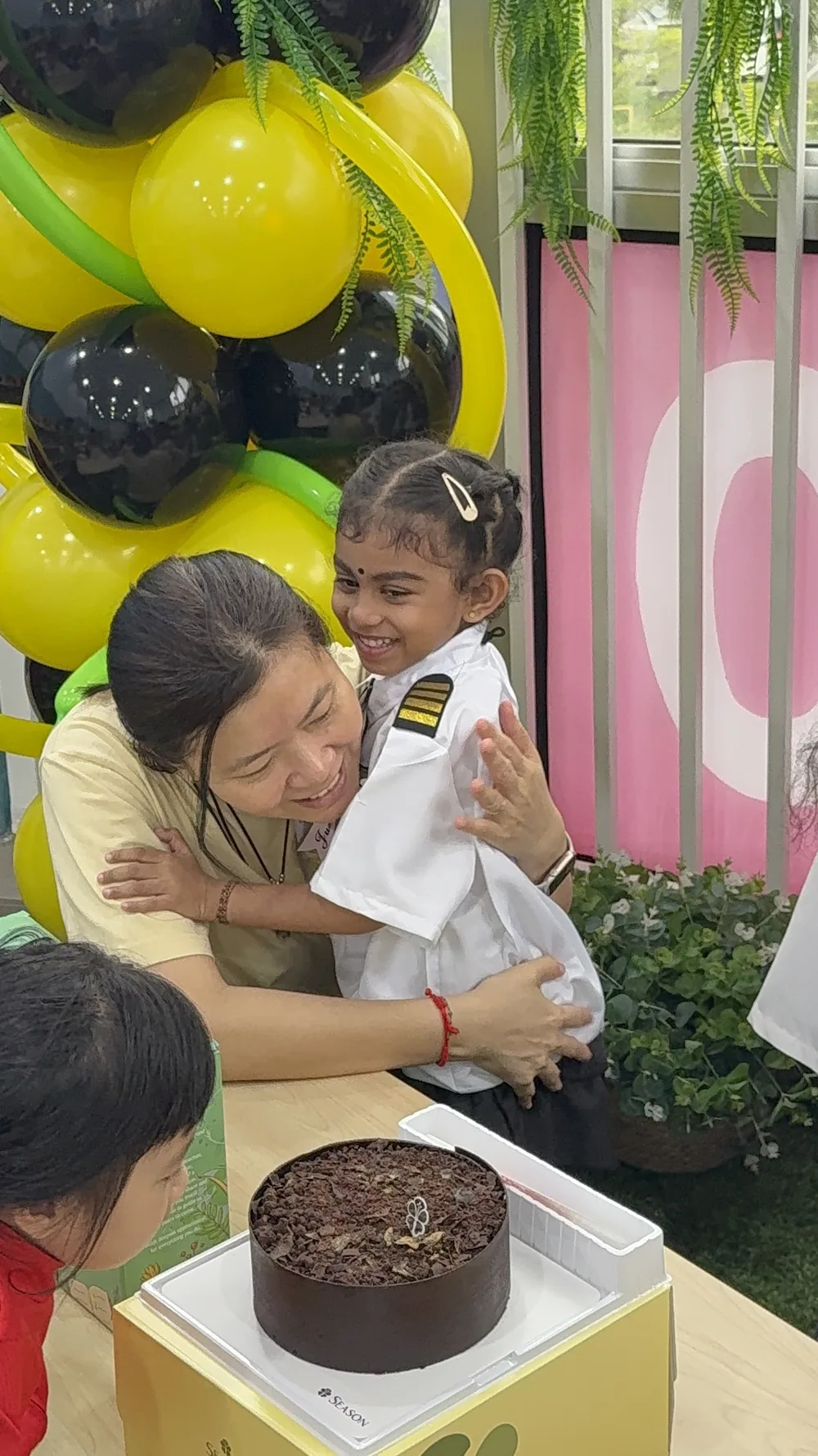 Educator supporting a child during a learning experience